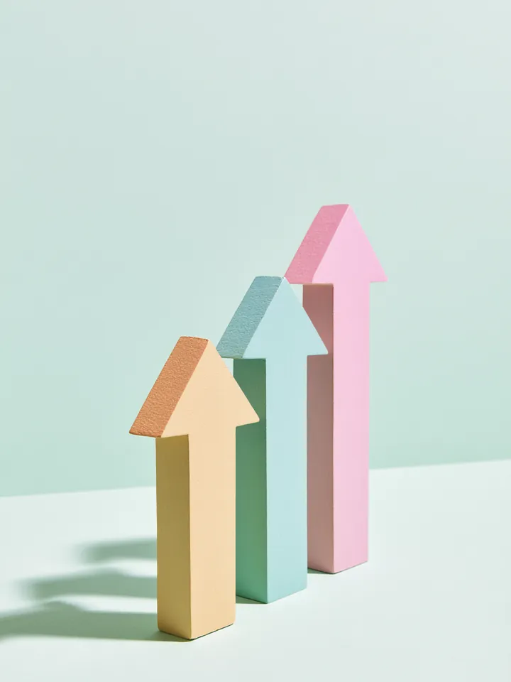 Three pastel wooden arrows pointing upward in a row, representing the steps of a Happy Money loan request